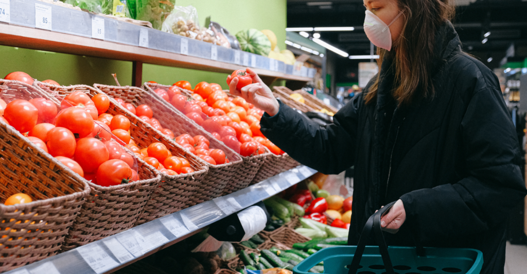 Woman shops with mask on to prevent the spread of COVID-19.