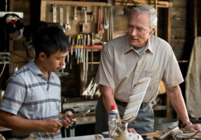 (L-r) Thao (BEE VANG) and Walt Kowalski (CLINT EASTWOOD) in Warner Bros. Pictures and Village Roadshow Pictures drama Gran Torino, distributed by Warner Bros. Pictures.